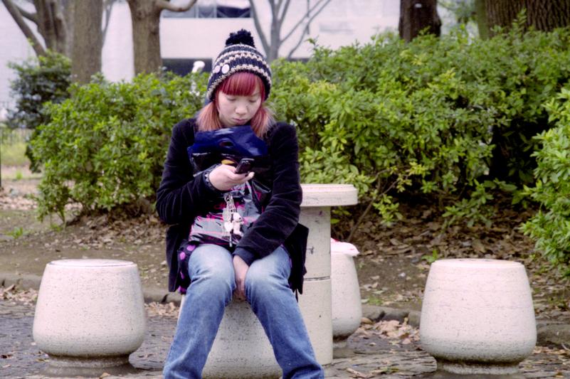 Une jeune femme consulte son téléphone.